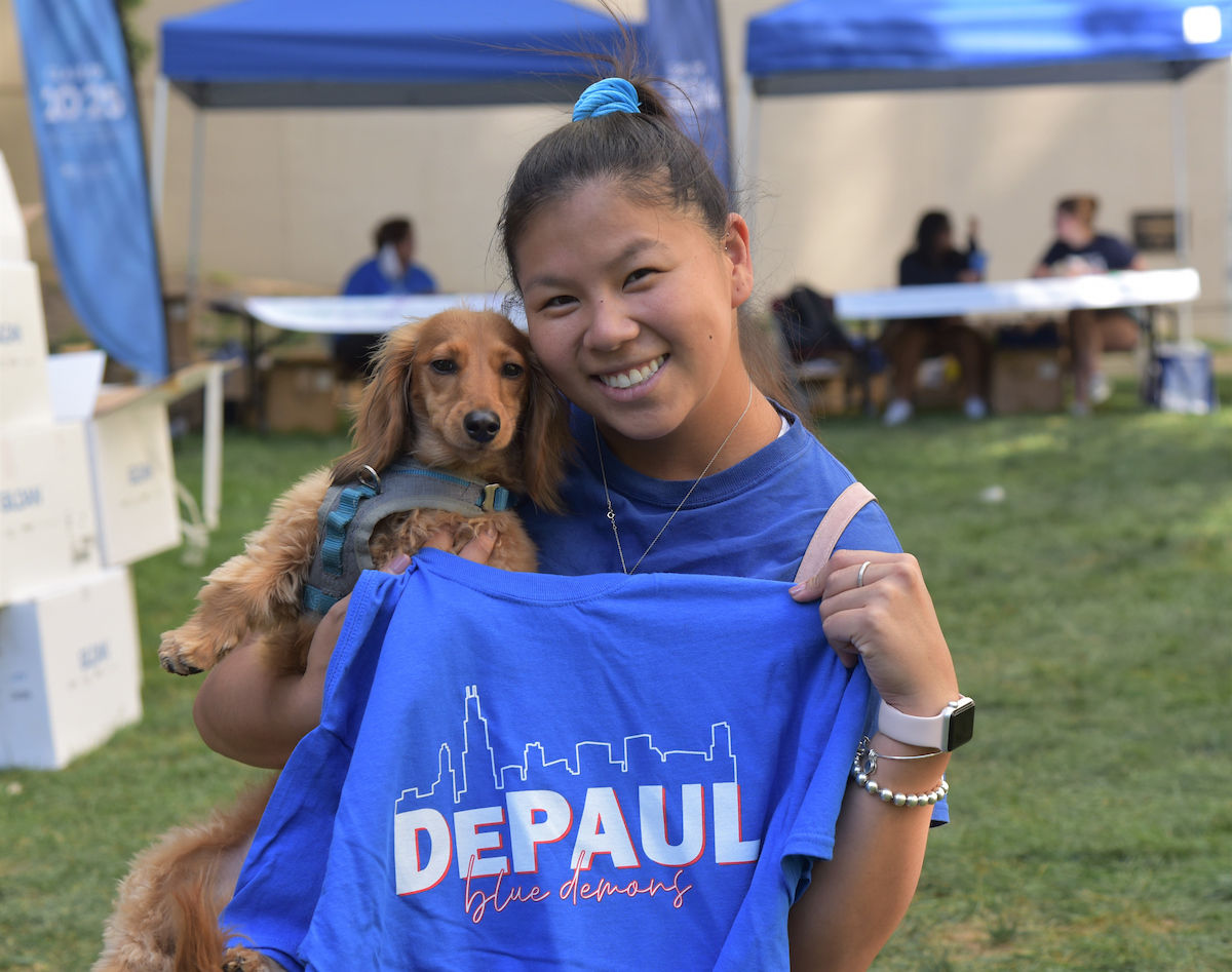 Student with DePaul t-shirt and dog